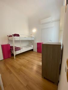 a room with two bunk beds and a wooden floor at My Friends in Florence