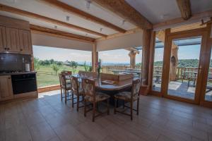 a kitchen with a table and chairs and a large window at Holiday Home Ernest Železni with hot tub in Ivančna Gorica