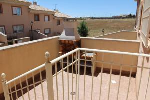 a white railing on a balcony of a building at Casa Rural La Sureña 2 in Ossa de Montiel