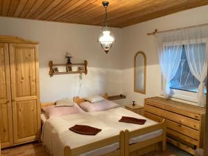 a bedroom with a large bed and a window at Chalupa na samote in Pliešovce