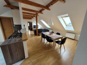 a kitchen and living room with a table and chairs at Apartmány Velké Dářko in Škrdlovice