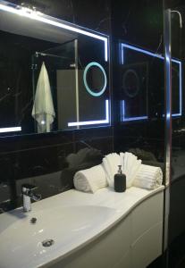 ein Badezimmer mit einem weißen Waschbecken und einem Spiegel in der Unterkunft Appartement T4 centre-ville, plage à 5 min à pied in Sainte-Maxime