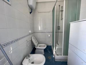 a bathroom with a toilet and a shower and a sink at Casa Giusto Ischia in Ischia
