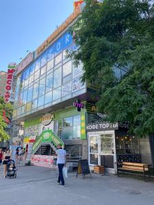 a woman is standing in front of a store at Апартаменты Бульвар Славы 21 in Dnipro