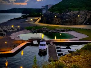 a boat is docked in a harbor at night at SnapNap in Storebö