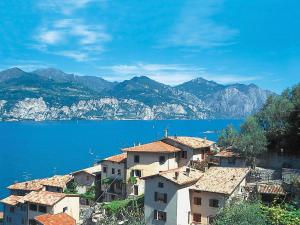 a group of houses on a hill next to the water at Apartment Casa Vigna by Interhome in Sommavilla