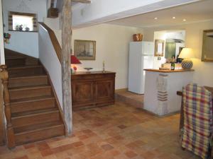 a living room with a staircase and a refrigerator at Holiday Home La Janverie - MNX200 by Interhome in Monteaux