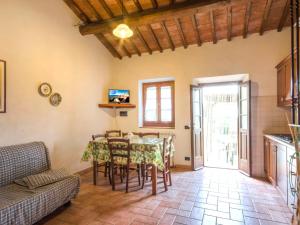 a kitchen and dining room with a table and chairs at Apartment Stregaia-1 by Interhome in Montaperti