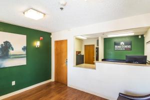 ein leeres Wartezimmer mit grüner Wand in der Unterkunft HomeTowne Studios Houston - West Oaks in Houston