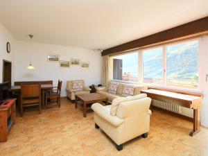 a living room with a couch and a table at Apartment Ringstrasse Apt 212 by Interhome in Leukerbad