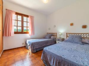 A bed or beds in a room at Holiday Home Ca Na Rosa by Interhome