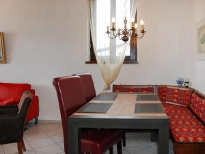 a dining room with a table and chairs at Apartment Residence Miralago - Utoring Apt- B19 by Interhome in Piazzogna