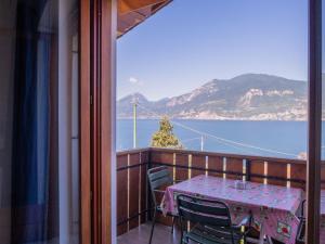 a table on a balcony with a view of the ocean at Apartment Delvai-1 by Interhome in Brenzone sul Garda