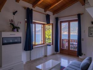 a living room with a view of the mountains at Apartment Delvai-1 by Interhome in Brenzone sul Garda +27 photos