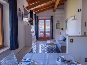 a living room with a table and a couch at Apartment Delvai-1 by Interhome in Brenzone sul Garda