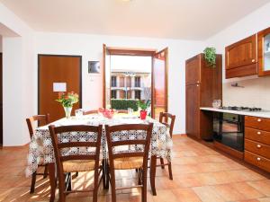 a kitchen and dining room with a table and chairs at Apartment Oak-4 by Interhome in Sorano