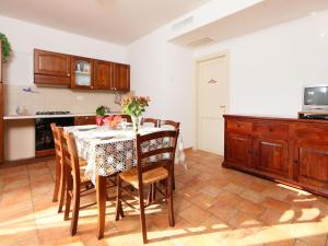 a kitchen with a table with chairs and a kitchen at Apartment Oak-4 by Interhome in Sorano