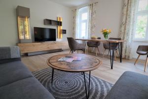 a living room with a couch and a table at Ferienwohnung zum Bielatal in Königstein an der Elbe