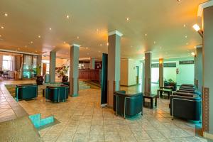 a lobby with chairs and tables in a building at Desmond Tutu Conference Centre in Nairobi