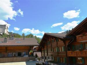 a group of wooden buildings sitting next to each other at Apartment Le Vieux Chalet by Interhome in Gstaad