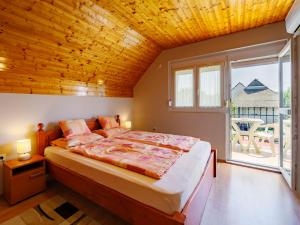 a bedroom with a bed and a large window at Apartment Swing by Interhome in Balatonszárszó