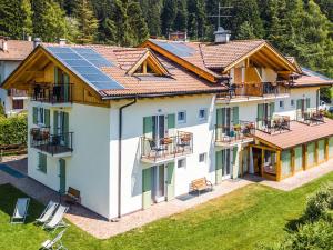 un’immagine di una casa con pannelli solari sul tetto di Apartment Pensione Villa Belfiore-1 by Interhome a Ronzone