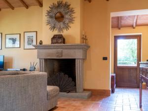 a living room with a fireplace with a mirror at Villa Casal di Yuri by Interhome in Vetralla