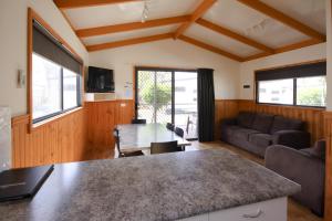 a kitchen and living room with a table and a couch at Sun Country Lifestyle Park in Mulwala
