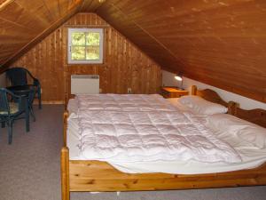 a bedroom with a large bed in a attic at Holiday Home Useriner See-4 by Interhome in Userin