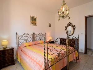 a bedroom with a bed and a mirror and a chandelier at Apartment Casa Teste di Moro by Interhome in Giardini Naxos
