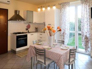 una cucina con tavolo e vaso di fiori di Apartment Roseto by Interhome a Cervo