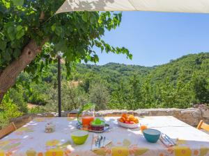 a table with a bowl of fruit on a table under a tree at Holiday Home Rosario by Interhome in Gessopalena