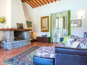 a living room with a blue couch and a fireplace at Holiday Home Cedri Alti-4 by Interhome in Ambra