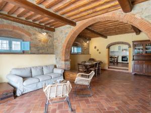 a living room with a couch and a table at Holiday Home Santa Lucia by Interhome in Castiglion Fiorentino