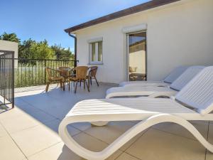 a pair of lounge chairs on the balcony of a house at Apartment File-2 by Interhome in Zambratija