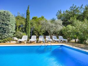 a group of chairs sitting next to a swimming pool at Apartment File-5 by Interhome in Zambratija