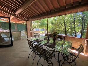 a patio with a glass table and chairs on it at Apartment Gufo-11 by Interhome in Podere Dottrina