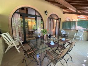 a dining room with a glass table and chairs at Apartment Gufo-11 by Interhome in Podere Dottrina