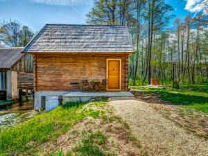 a log cabin with a table and chairs in front of it at Chalet Plitvice II by Interhome in Rudanovac