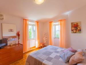 Schlafzimmer mit einem Bett, einem TV und Fenstern in der Unterkunft Holiday Home Erika by Interhome in Ripatransone