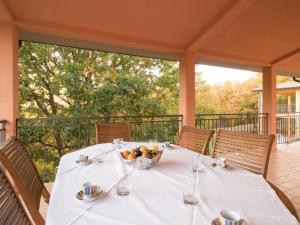 a table with a bowl of fruit on a porch at Holiday Home Thermae Villa 34 by Interhome in Sorano