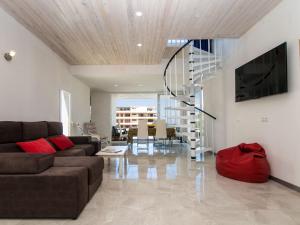 a living room with a couch and a staircase at Villa Betlem by Interhome in Colonia de Sant Pere