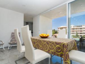 a dining room with a table with a bowl of fruit on it at Villa Betlem by Interhome in Colonia de Sant Pere