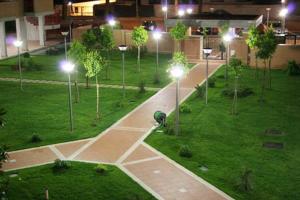 an empty park at night with street lights at Residence I Triangoli in Infernetto