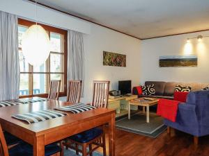 a living room with a dining table and a couch at Holiday Home Saariseläntie 8 a 1 by Interhome in Saariselka +15 photos