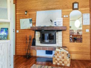 a living room with a fireplace in a house at Holiday Home Saariseläntie 8 a 1 by Interhome in Saariselka