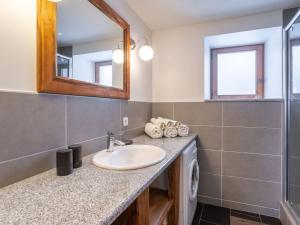a bathroom with a sink and a mirror at Apartment La Trace Blanche by Interhome in Villaroger