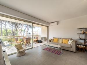 a living room with a couch and a table at Studio De la Plage-3 by Interhome in Cavalaire-sur-Mer