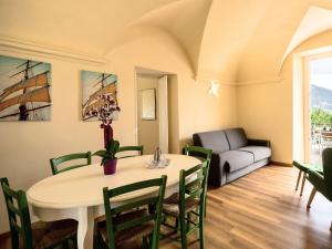 a living room with a table and chairs and a couch at Apartment Verde by Interhome in Porto Valtravaglia +32 photos
