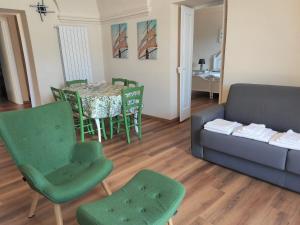 a living room with a couch and a table and chairs at Apartment Verde by Interhome in Porto Valtravaglia